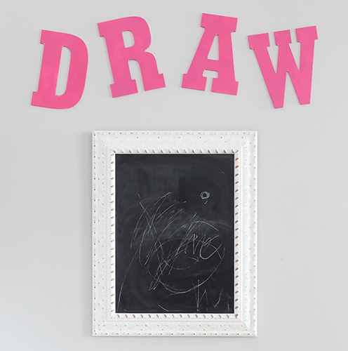 Draw letters on wall with chalkboard in frame